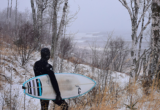 Keala Ede ’00 prepares to surf on Lake Superior in Minnesota.