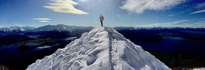 Oxy student Annika Smith standing at the summit of Roy's Pea