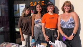 Four staff members from Project SAFE posing together at a table