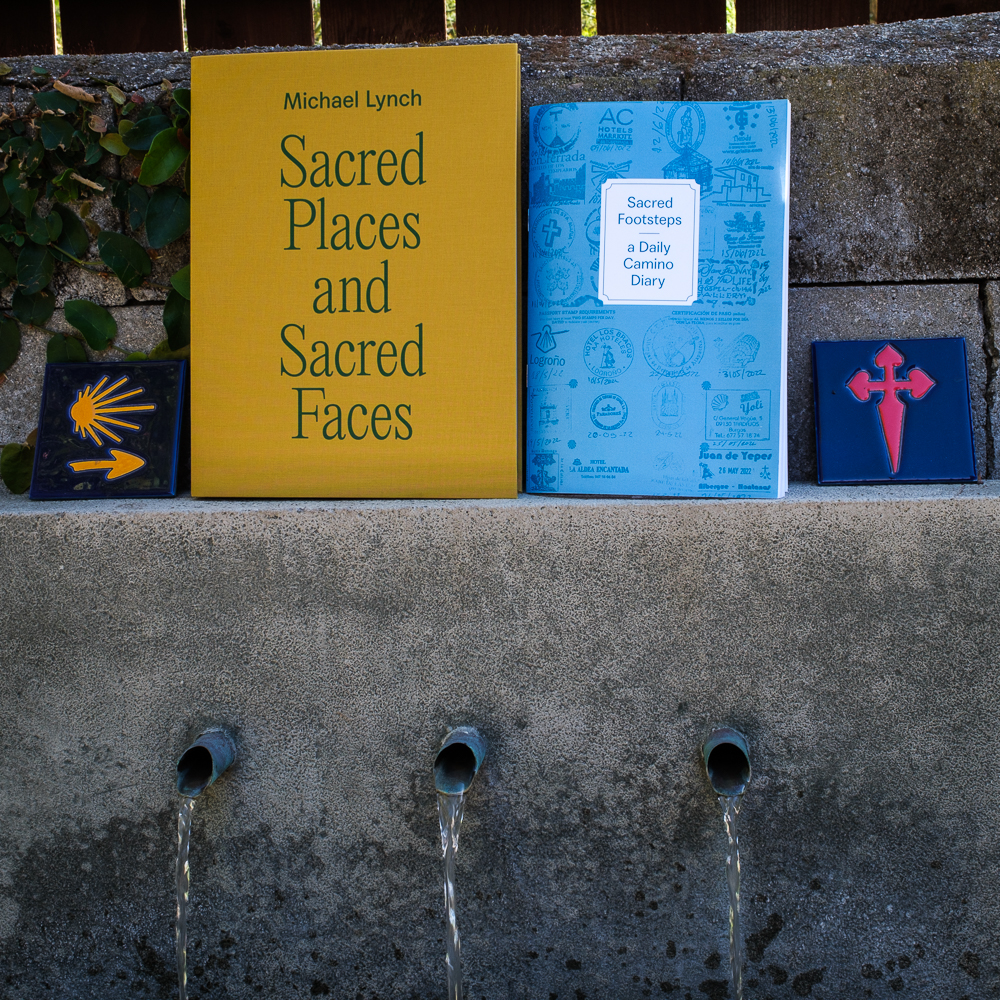 0fbbdf4a-c735-63f7-a475-13992b069c56.jpg Colorful photo of two books sitting on a cement ledge.