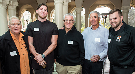 From left, arry Layne ’71, Bryan Scott ’17, Ron Botchan ’57, Jim Mora ’57, and Assistant Coach Casey Landry at a March 2018 event to support the Oxy football program.