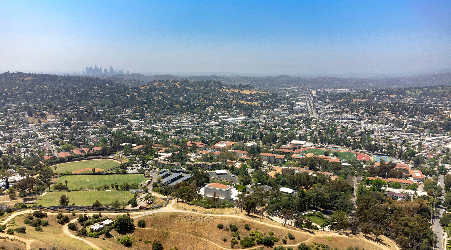 drone shot of campus with downtown LA in the background