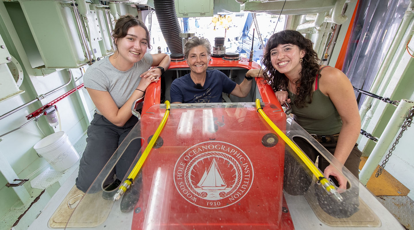Two students pose with Professor Goffredi by the submersible research vessel Alvin