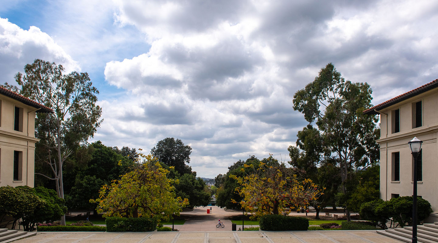 a view of campus buildings and the open cloudy sky