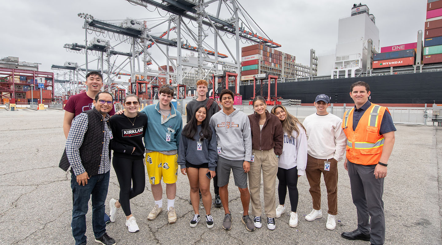 a group of Occidental College with their professor standing at the Port of Los Angeles on a field trip