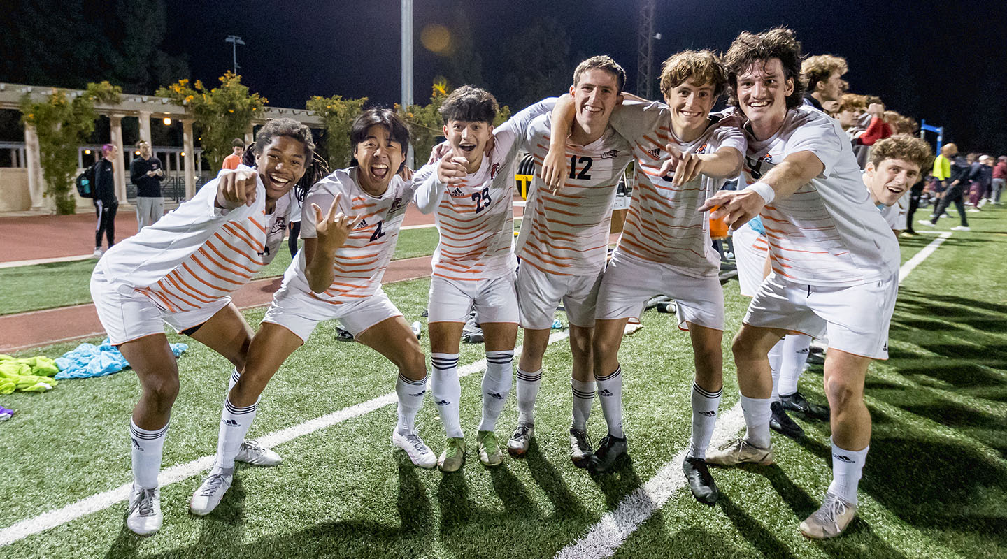 Oxy men's soccer players celebrate their victory on the field