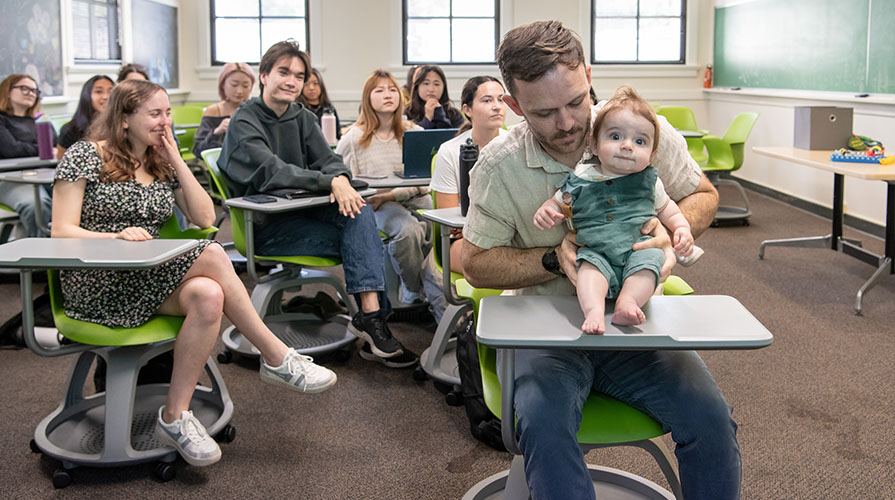 An Occidental College classroom with Professor Nicholas Grebe and his baby son