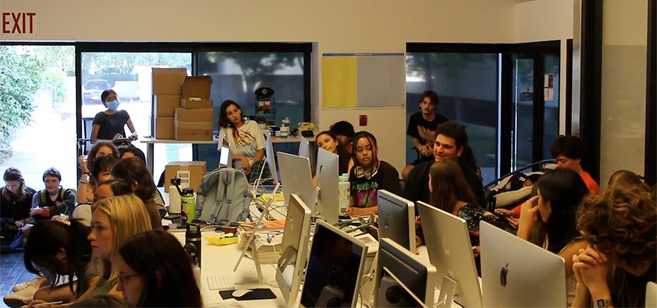 Occidental (OXY) students working and chatting in the Occidental Newsroom