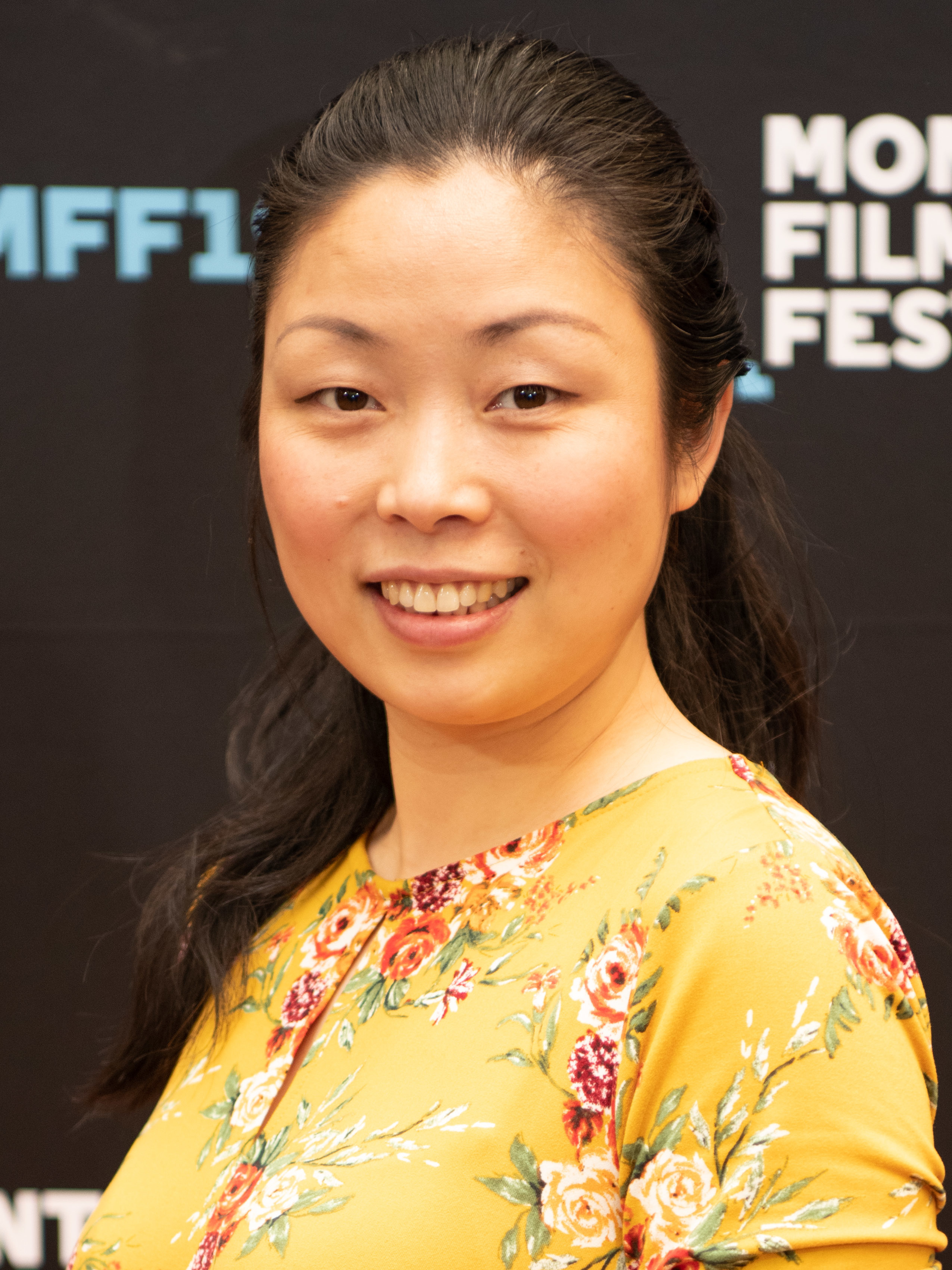 220px-Nanfu_Wang_2019.jpg Nanfu Wang smiling in a yellow floral dress against a black background.