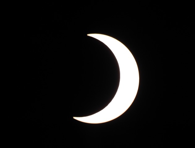 Partial Solar Eclipse 10/14/23 Partial solar eclipse with moon covering the majority of the sun from the left.