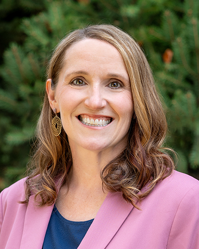 Angie Bos headshot in a pink jacket