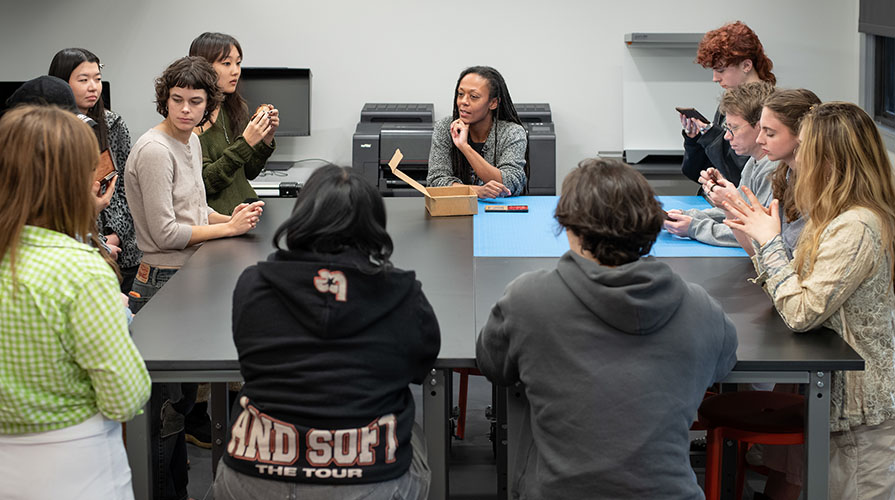 An Occidental College classroom full of students and a professor around a square table