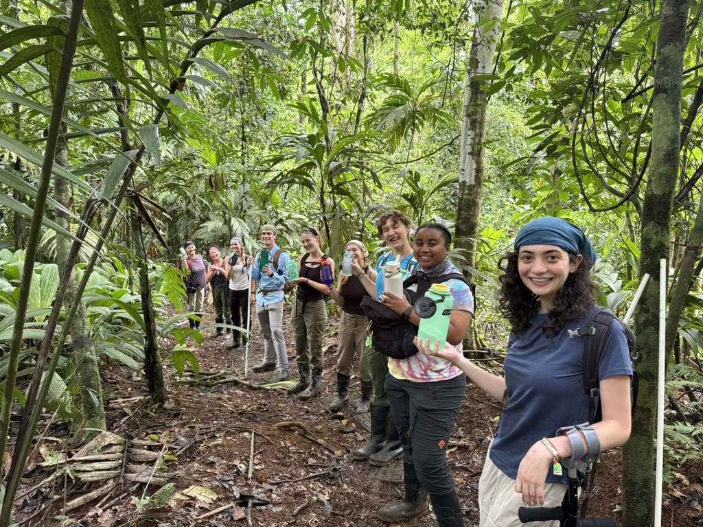 Several people in front of trees