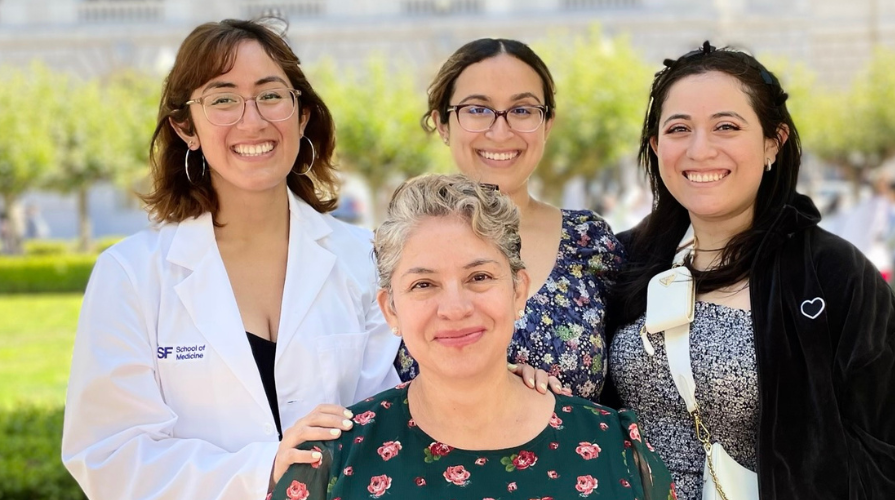 Dafna Erana Hernandez in a white coat with three women