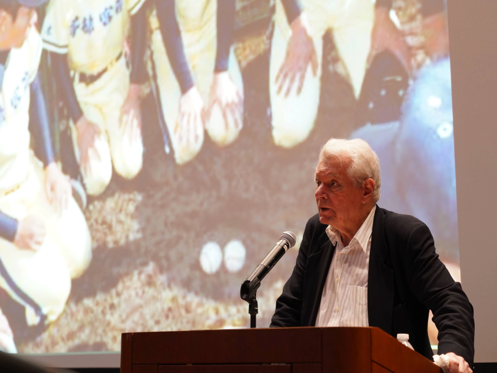 Image of Robert Whiting giving a presentation at a podium.