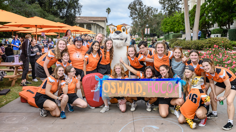 Oxy students with Oswald holding a Homecoming banner