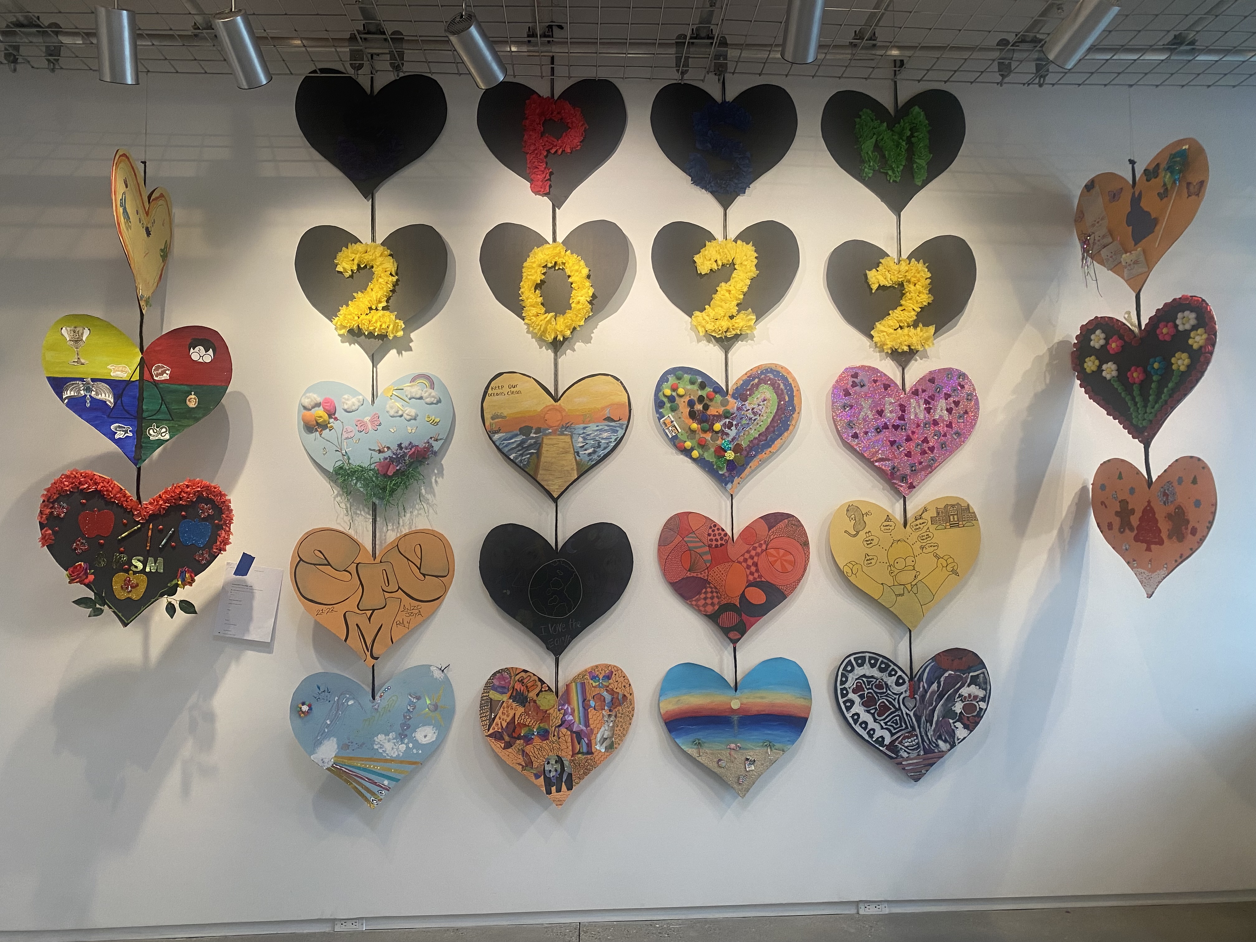 IMG-8155.jpg Decorated paper hearts hung vertically with 2022 written across the center.