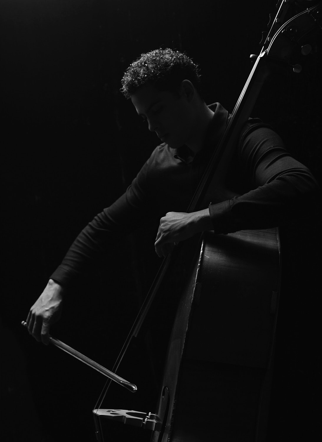 black and white photo of a man playing an upright bass 