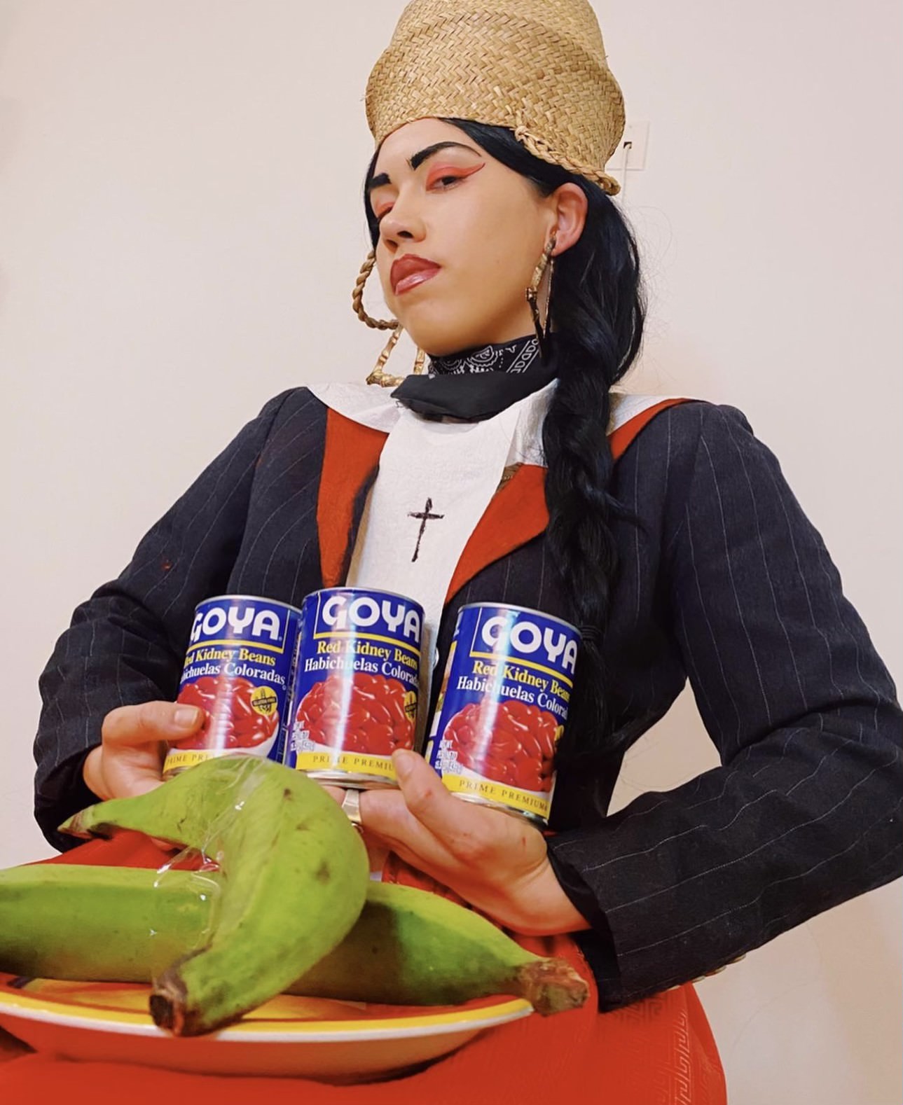 IMG_2107.jpg T Moreta holding Goya cans and plantains