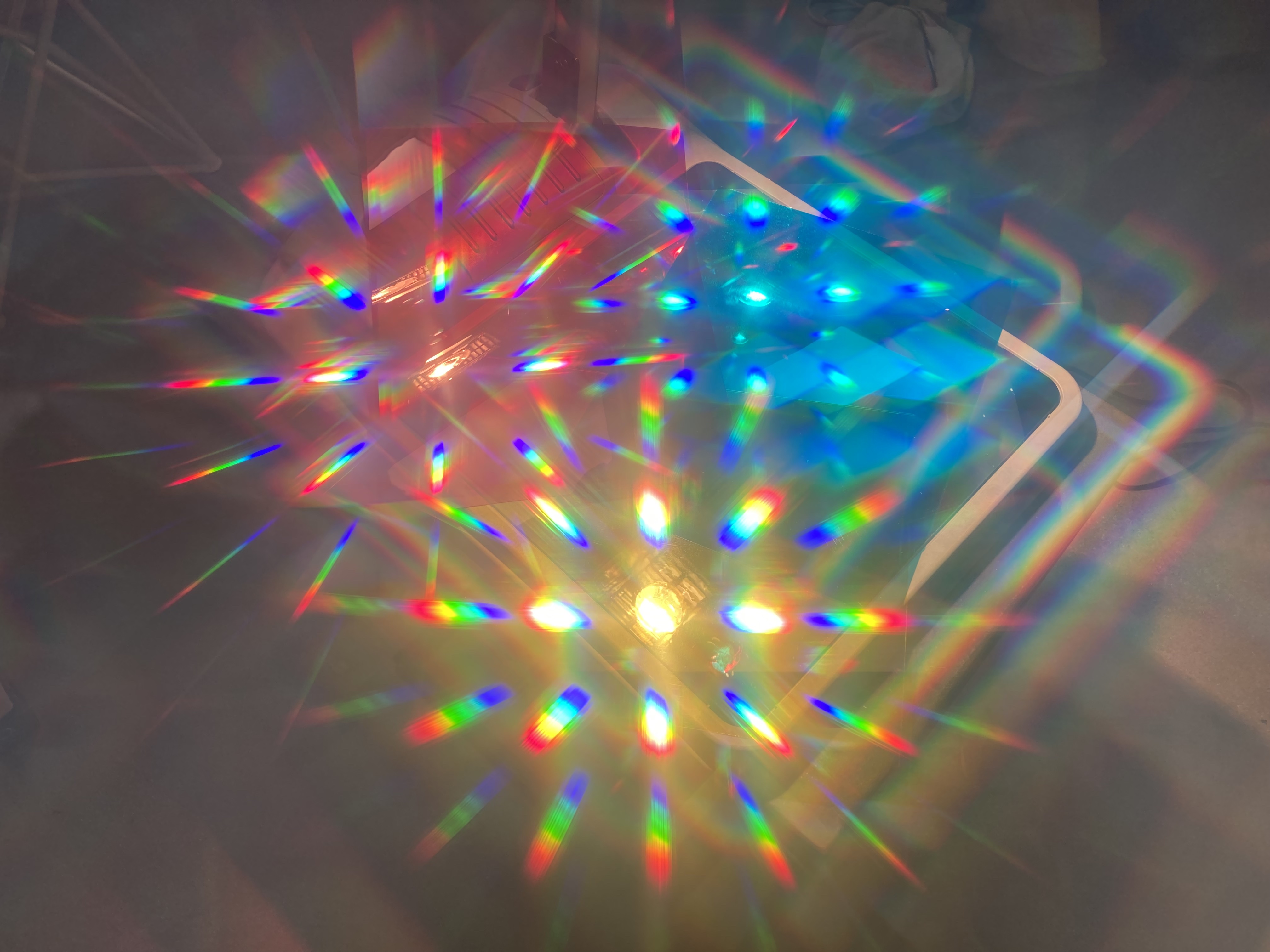 Prisms refracting yellow, blue and red light in an abstract pattern 