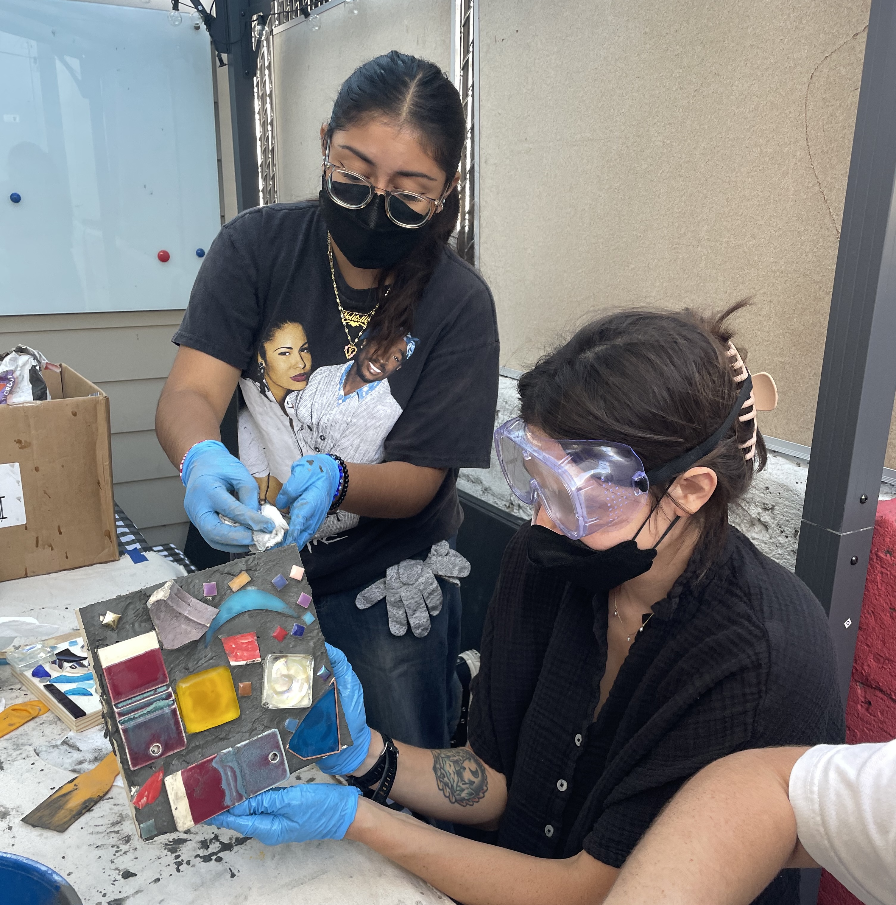 artist displaying finished mosaic