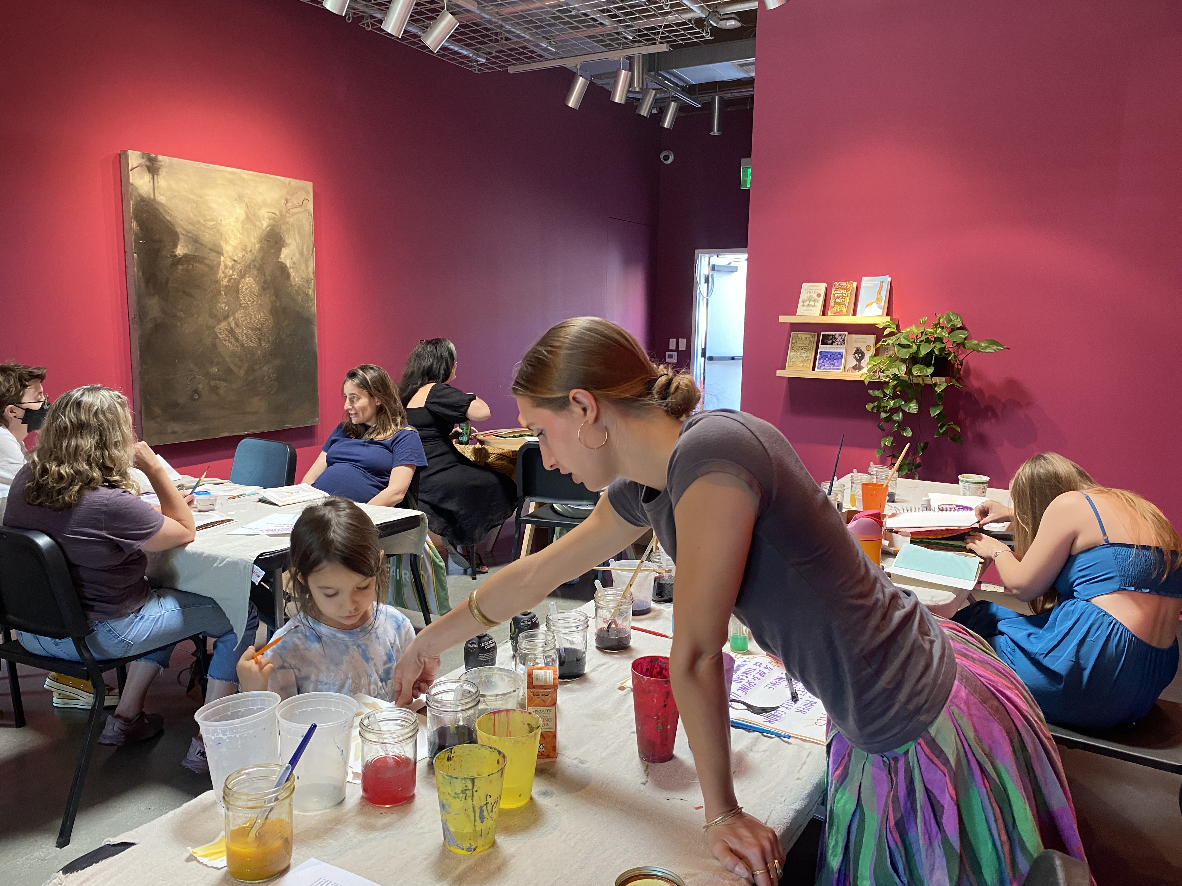 Teacher helping a student select natural ink. 