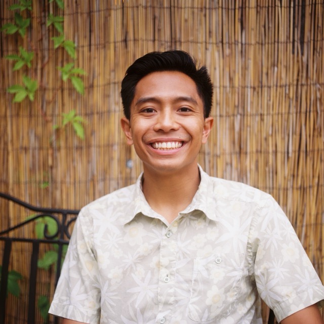Man in white shirt in front of brown background