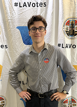 Julian Levy headshot in front of an "LA Votes" backdrop