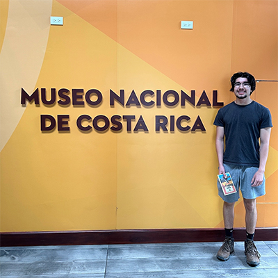 Julian Villa standing next to museum sign