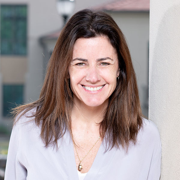 Lindsey Collins headshot with Oxford shirt and brown hair