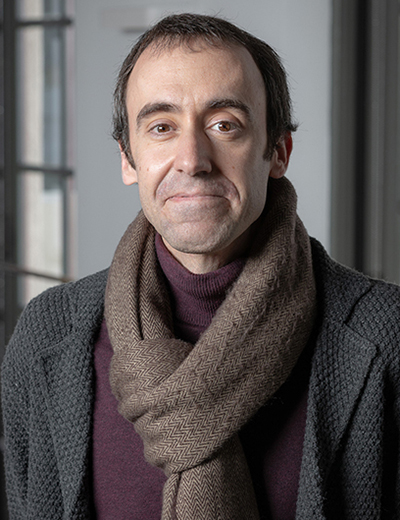 Alberto Lopez Martin headshot with brown scarf