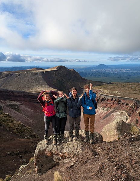 Occidental College students and faculty researching in the field on a mountain in New Zealand