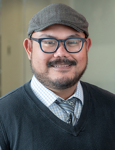 Frank Macabenta headshot with grey cap
