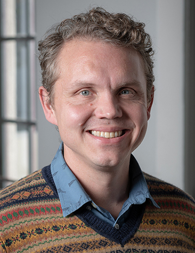 Dusty Madison headshot in vneck sweater