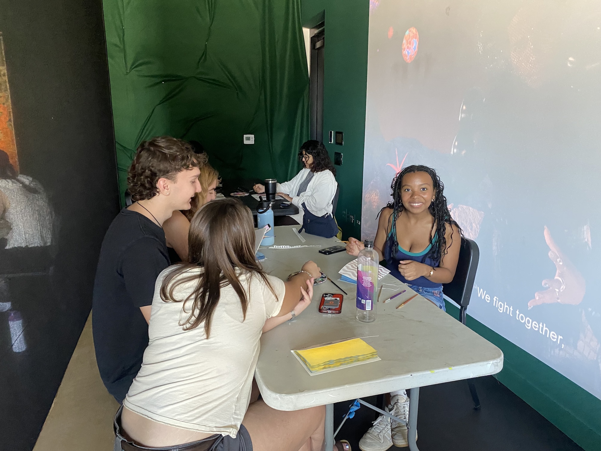 color image of four people creating books at an arts workshop