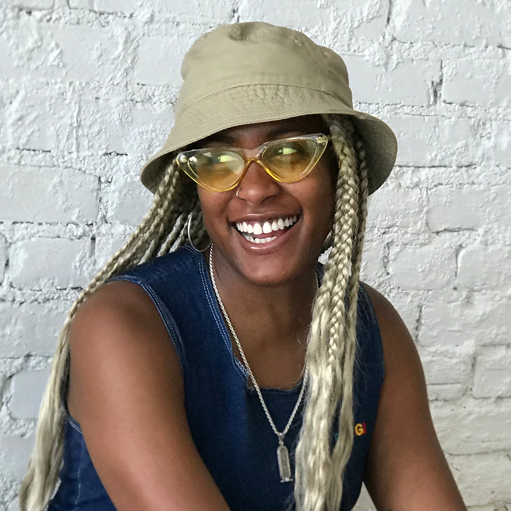 Mandy-Harris-Williams1.jpeg Mandy looking to the side with a beige hat and tank top