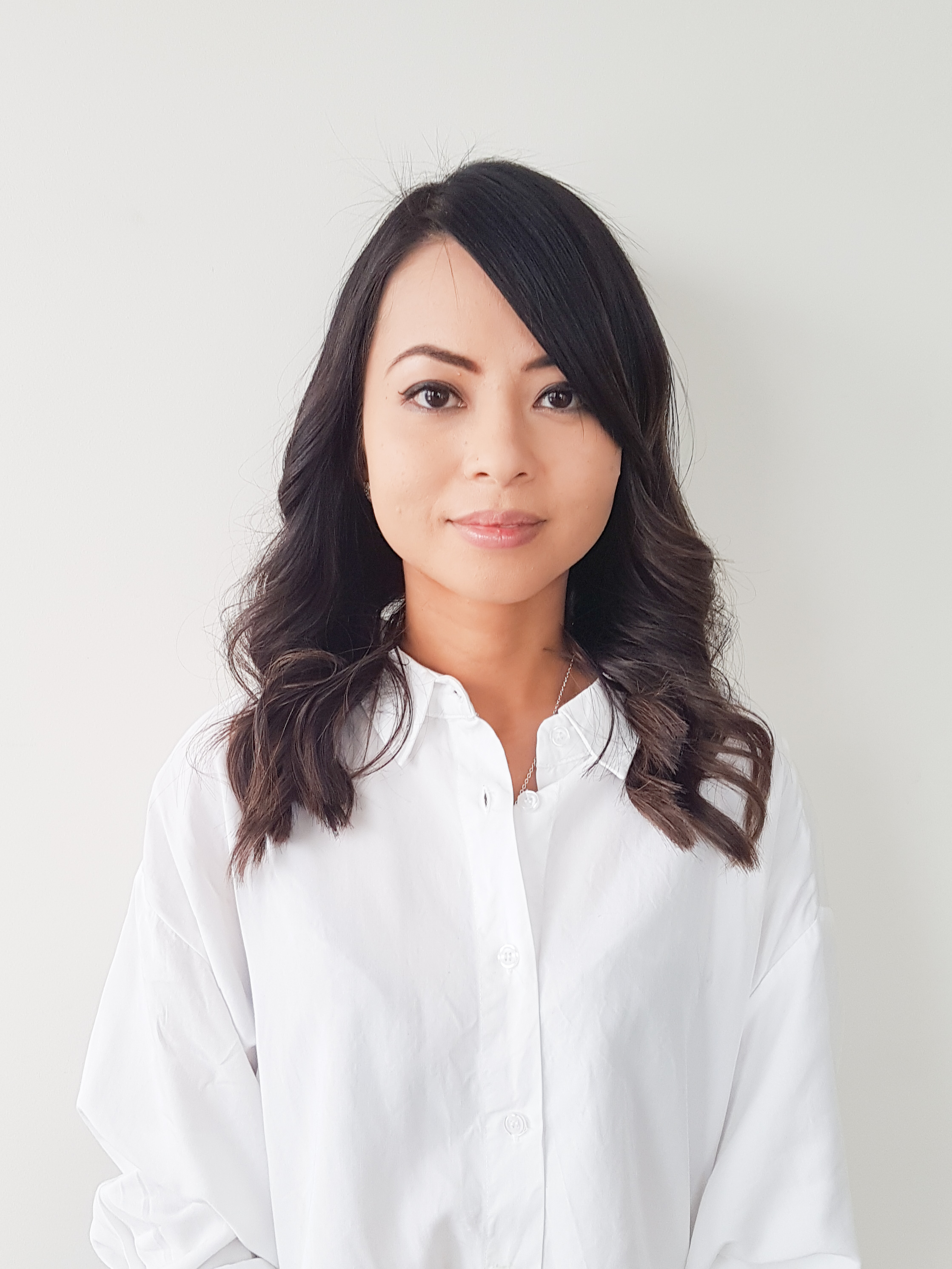 Woman in white shirt in front of white background