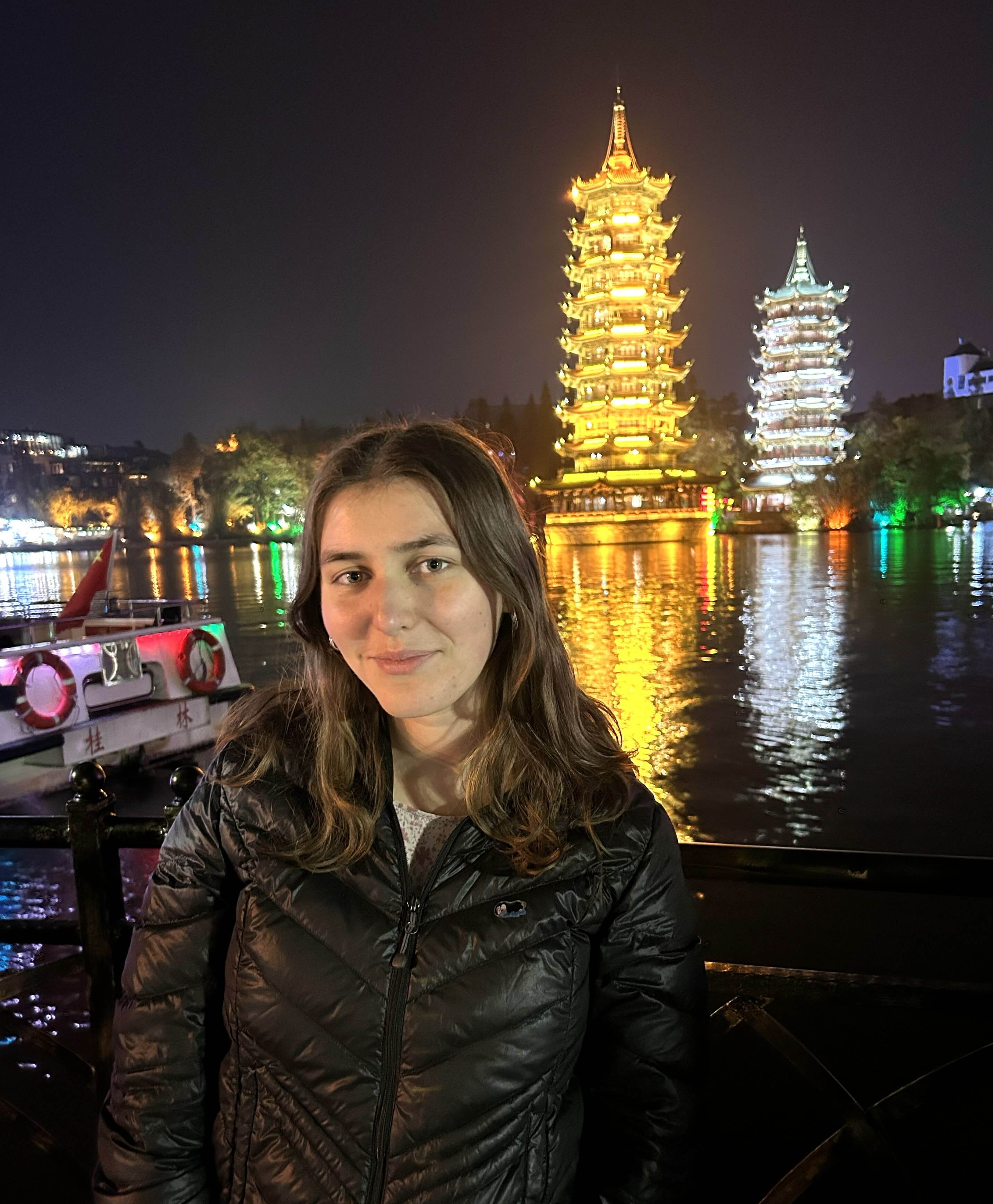 Photo of Meredith Burke with the Sun and Moon Pagodas in the background. Guilin, Guangxi, China