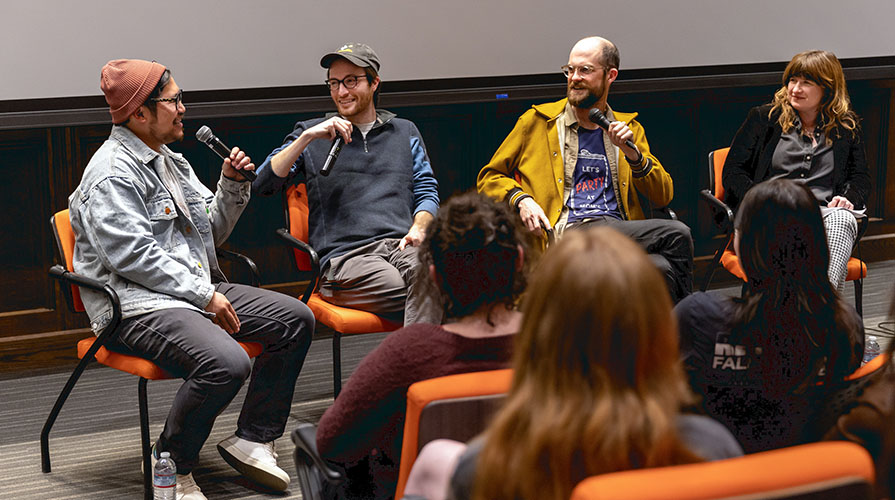 Four filmmakers sit on stage in a panel with microphones