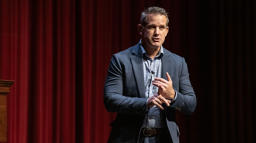 Republican Adam Kinzinger on a stage in Thorne Hall