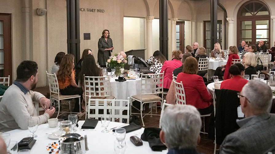 Lynn Mehl talking in front of a large group of seated people