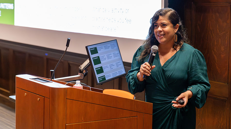 Maya Soetoro-Ng gives a lecture at a lectern in Choi Auditorium