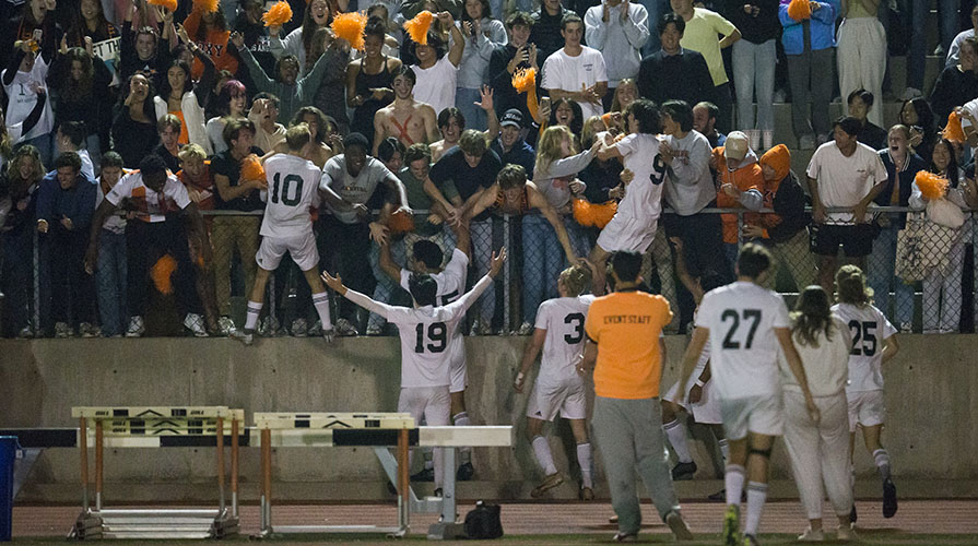 Soccer players approach the fans in the stands joyfully after their win