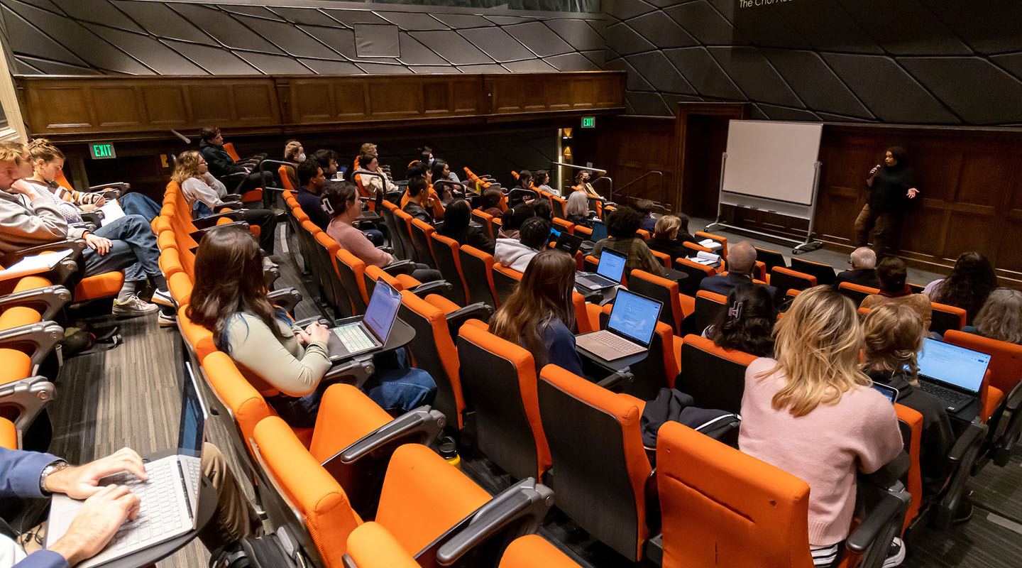 Choi Auditorium filled with people and a guest speaker up front