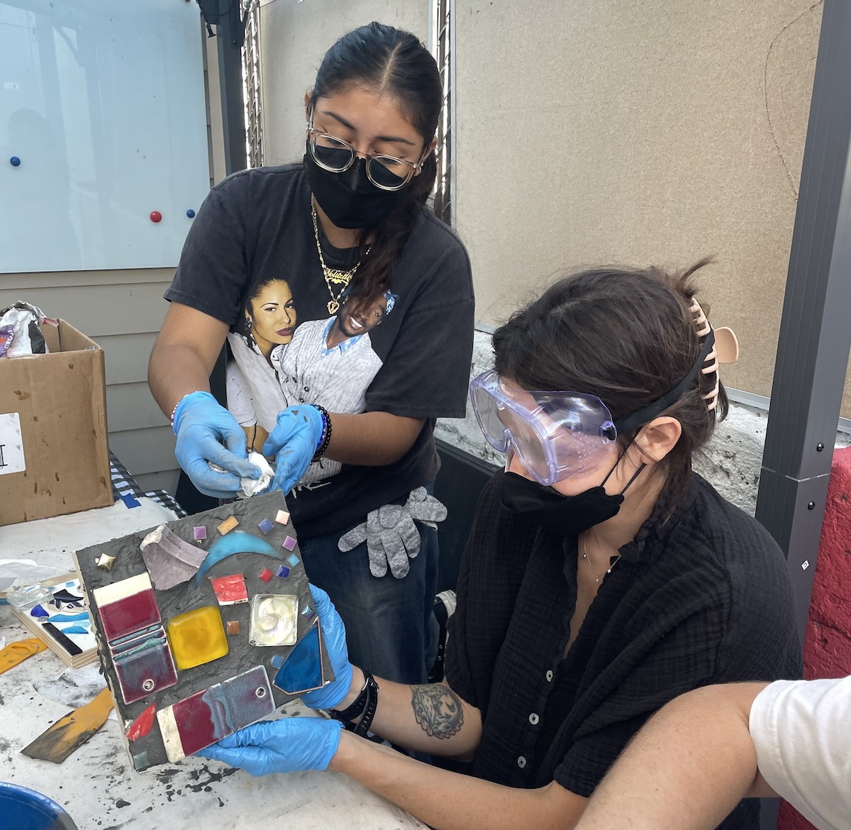 color image of a workshop participant making a mosaic