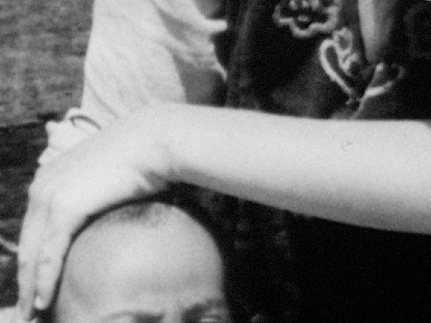 Oraib Toukan Via Dolorosa 2.png Still from the film Via Dolorosa by Oraib Toukan, abstract archival shot of a person's head and another person's arm