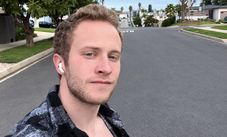 Occidental Student posing for photo in residential neighborhood