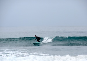 occidental student surfing in Malibu, CA