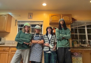 Occidental students posing for photo inside a kitchen