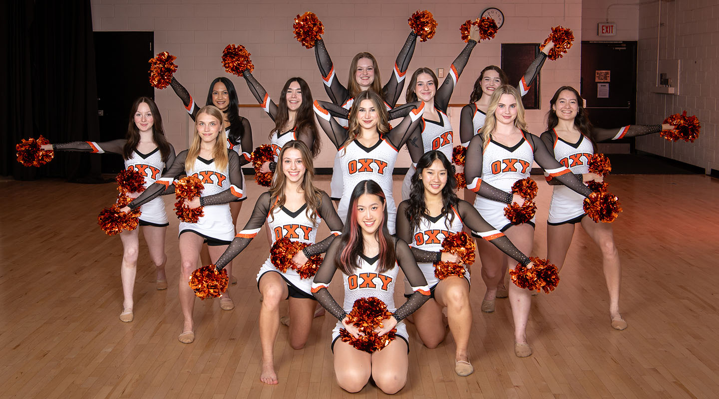 The Occidental College Dance team posing in a formation in their uniforms